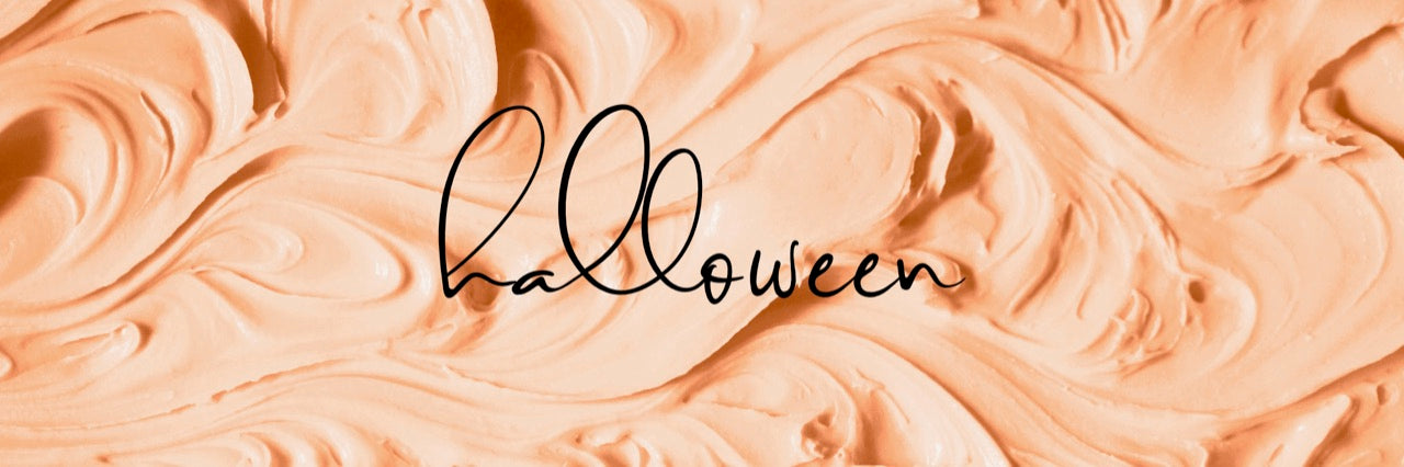 a background of orange icing with the word "halloween" on top