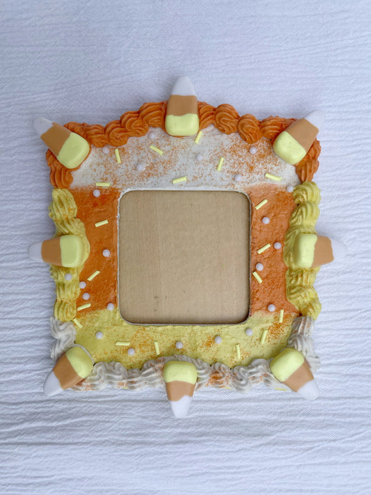 a mini picture frame decorated like a candy corn coloured cake