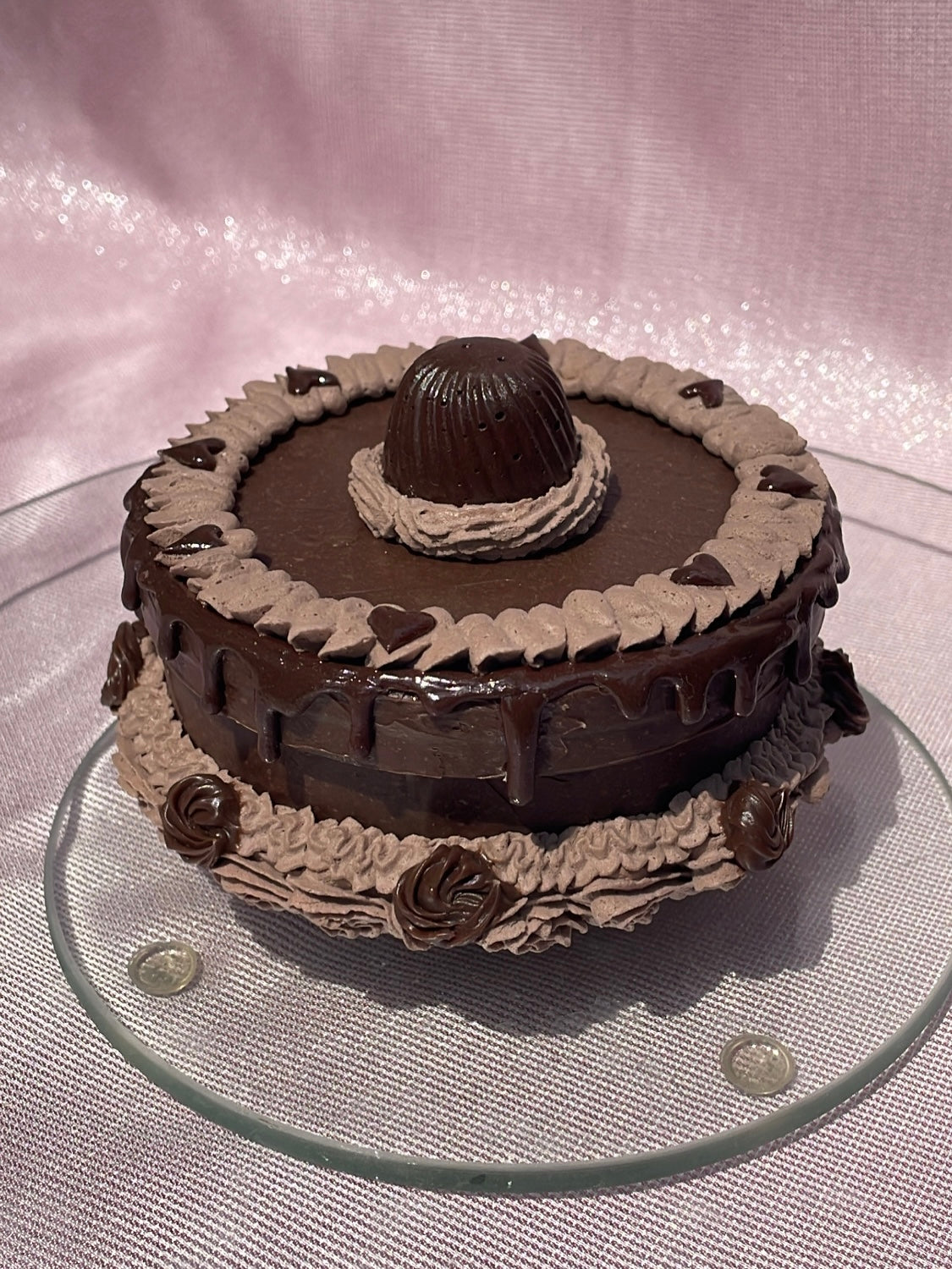 a round box decorated to look like a chocolate cake