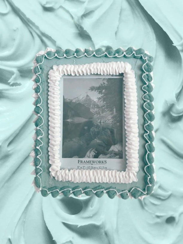 a picture frame decorated to look like a turquoise cake